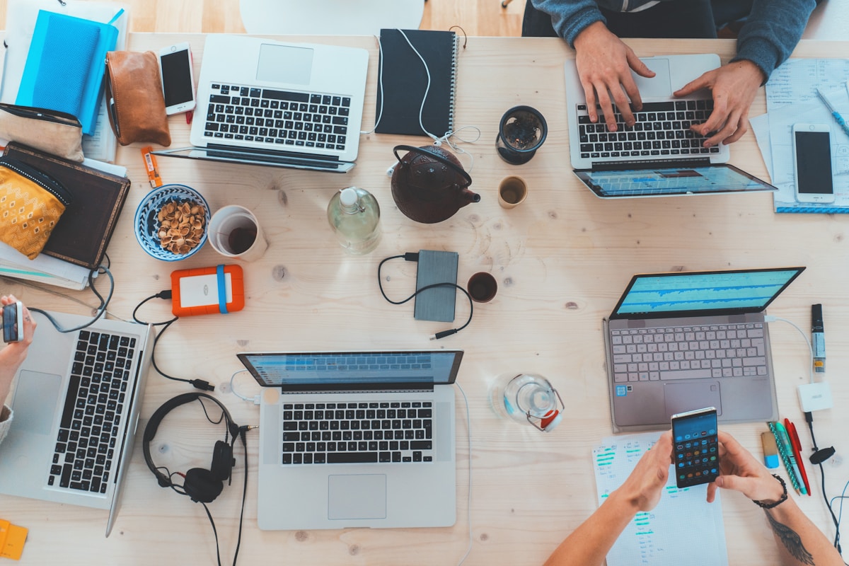 Modern desk setup with laptop and notebook